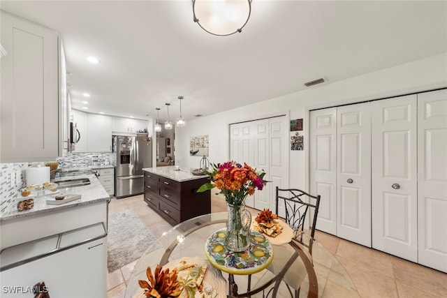 dining area with light tile patterned flooring