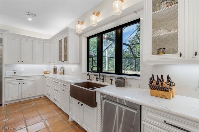 kitchen featuring stainless steel dishwasher, light stone countertops, white cabinetry, and sink