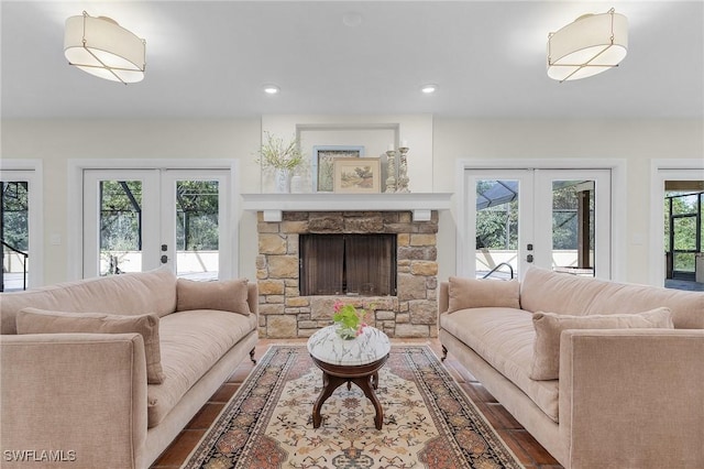 3628 Heritage Ln, Fort Myers, FL 33908 - living room featuring french doors, recessed lighting, and a stone fireplace