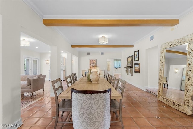 tiled dining space featuring baseboards, visible vents, crown molding, and french doors