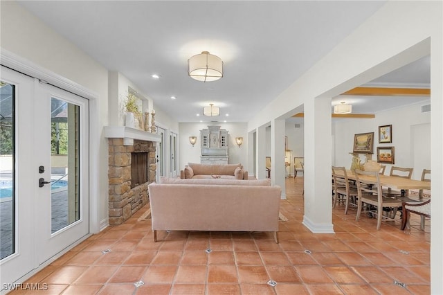 living room featuring light tile patterned floors, a fireplace, baseboards, and recessed lighting