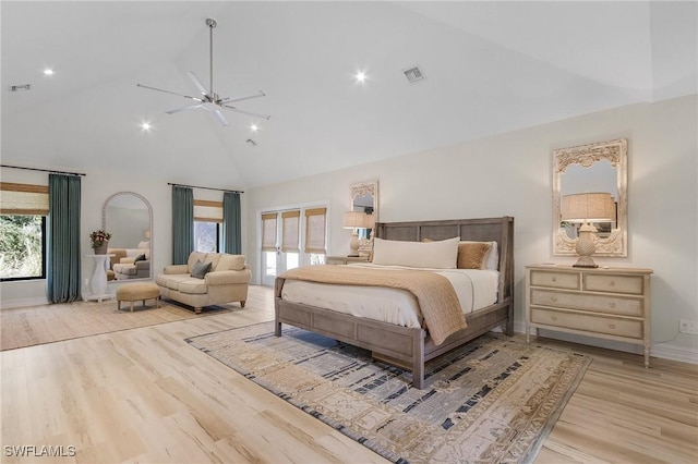 bedroom featuring light wood-style floors, visible vents, high vaulted ceiling, and baseboards