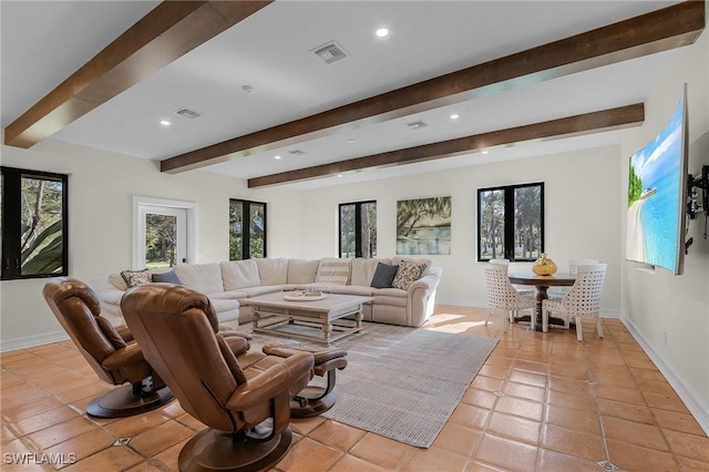 living room featuring beamed ceiling and light tile patterned floors