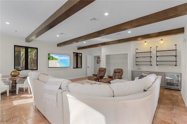 tiled living room featuring beamed ceiling, wine cooler, and french doors