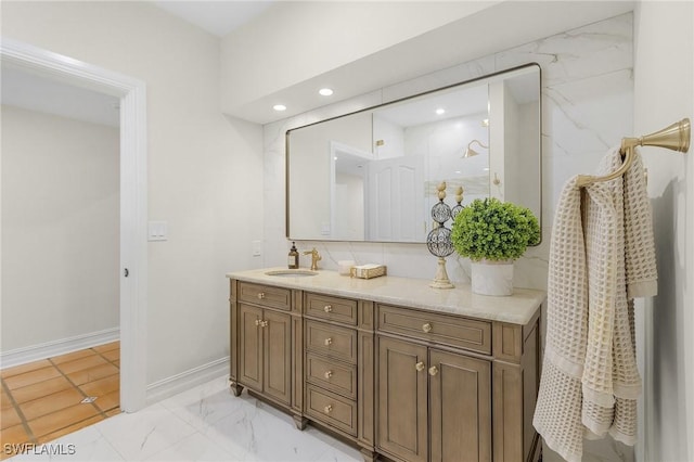 full bath with recessed lighting, vanity, baseboards, marble finish floor, and a marble finish shower