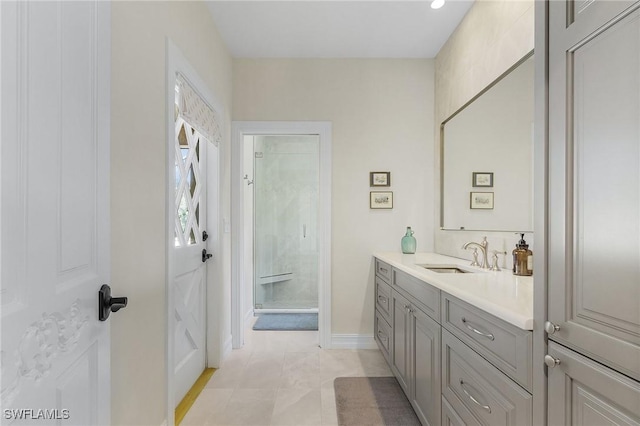 bathroom with tile patterned floors, vanity, and walk in shower