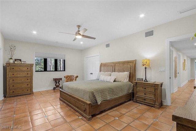 bedroom with ceiling fan, light tile patterned floors, and a closet