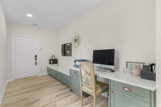 office area with light wood-style flooring, visible vents, baseboards, and recessed lighting