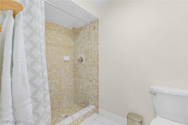 full bathroom featuring toilet, a stall shower, baseboards, and tile patterned floors