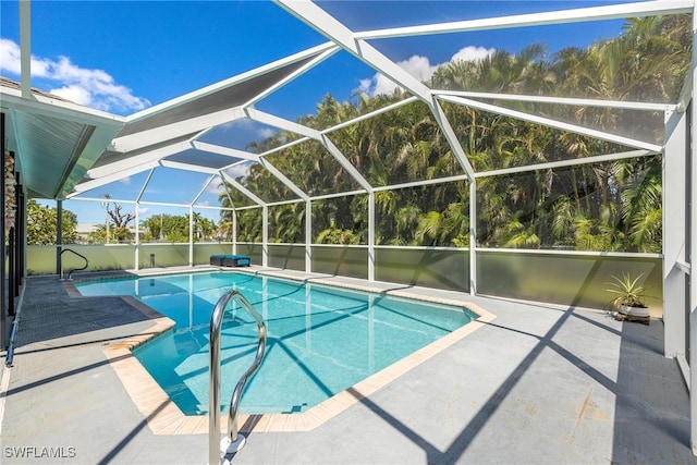 view of pool featuring a patio area and glass enclosure