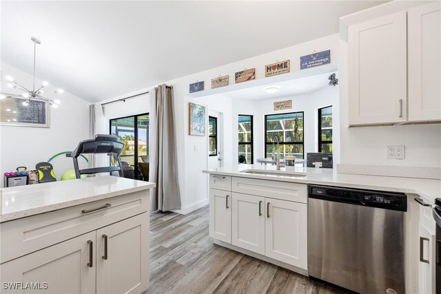 kitchen with dishwasher, vaulted ceiling, a healthy amount of sunlight, and sink