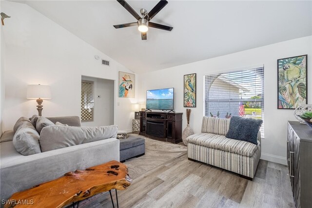 living room with high vaulted ceiling, light hardwood / wood-style flooring, and ceiling fan