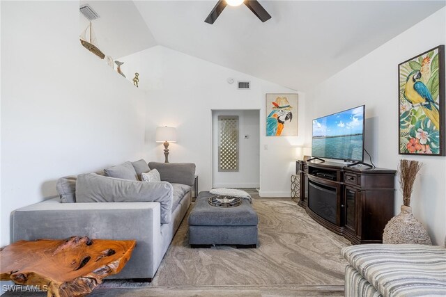 living room with ceiling fan, light colored carpet, and lofted ceiling