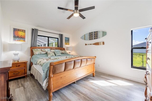 bedroom with ceiling fan, light hardwood / wood-style floors, and lofted ceiling