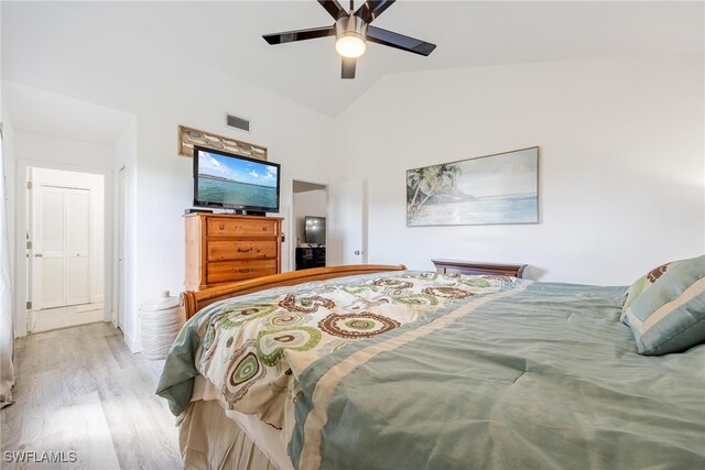 bedroom featuring ceiling fan, lofted ceiling, and light wood-type flooring