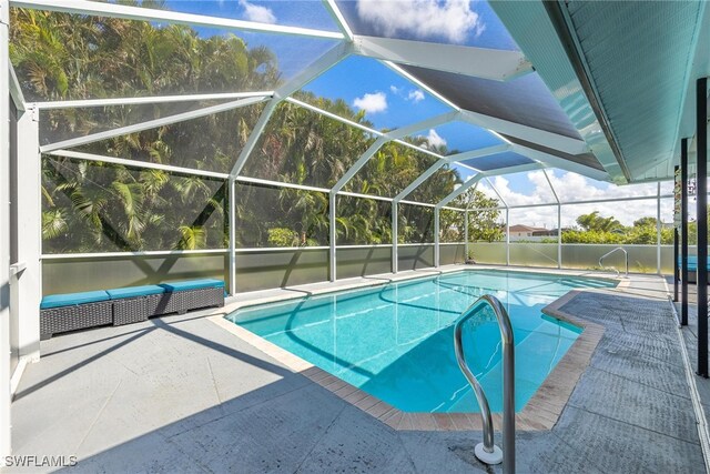 view of pool featuring a patio and glass enclosure