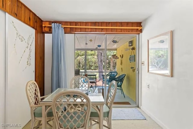 dining area featuring wood walls