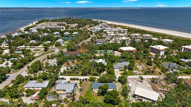 bird's eye view with a water view and a beach view