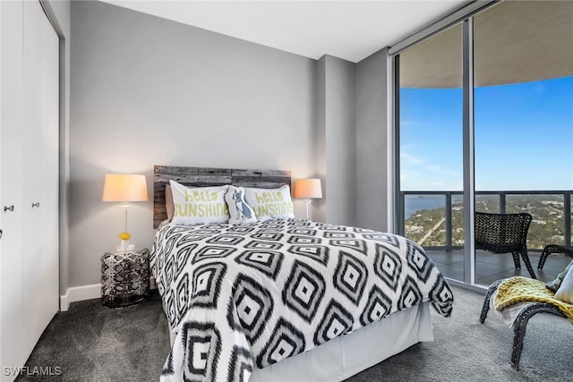 carpeted bedroom featuring a wall of windows and access to outside