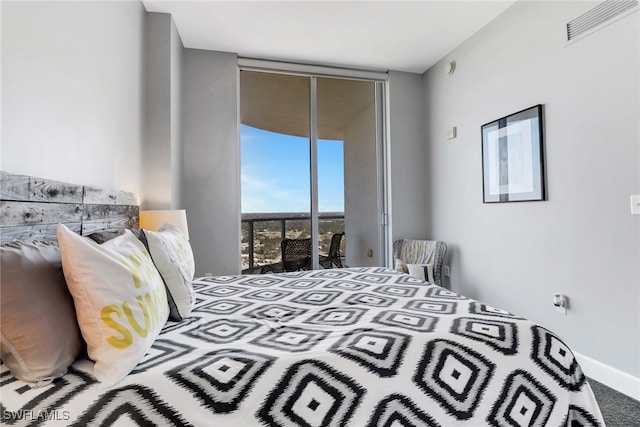 bedroom with floor to ceiling windows and access to outside