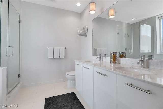 bathroom featuring tile patterned flooring, vanity, toilet, and walk in shower