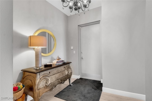 foyer entrance with an inviting chandelier and light wood-type flooring