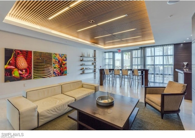 interior space with expansive windows and a tray ceiling