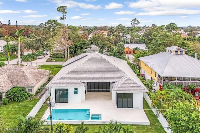 back of property featuring a lawn and a patio