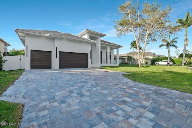 1317 Cypress Woods Dr, Naples, FL 34103 - prairie-style home with a front lawn, an attached garage, and decorative driveway