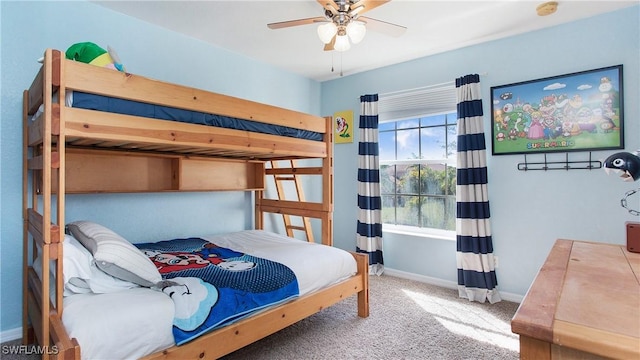 bedroom with light colored carpet, ceiling fan, and baseboards