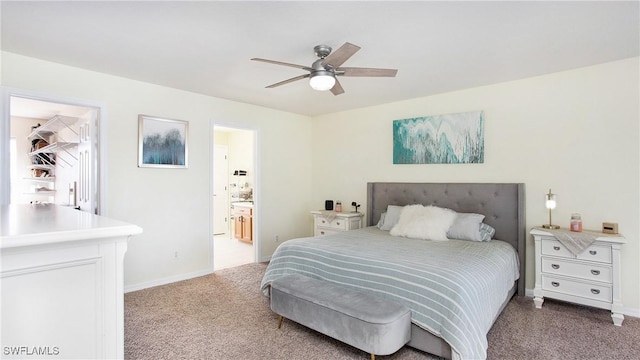 bedroom with light carpet, ceiling fan, baseboards, and ensuite bathroom