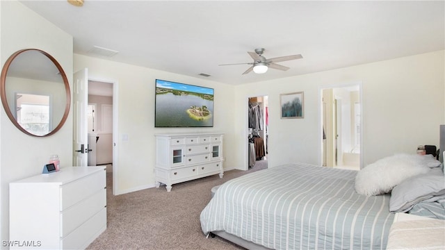 2864 Blossom Ct, Naples, FL 34120 - bedroom featuring light colored carpet, a walk in closet, ensuite bath, and a ceiling fan