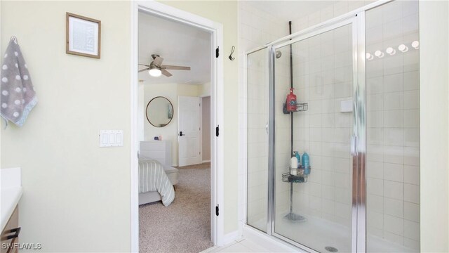 bathroom featuring ceiling fan, a shower with door, and vanity