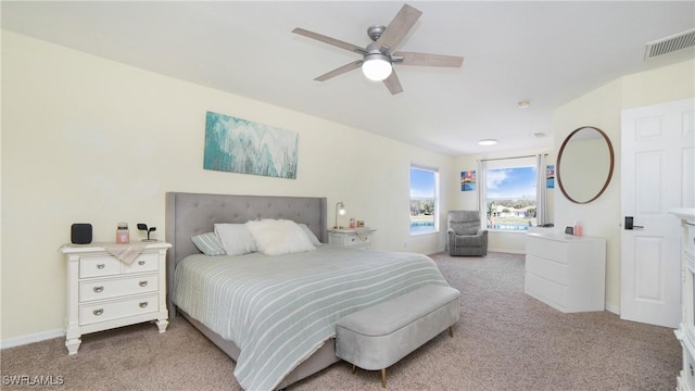 bedroom with baseboards, ceiling fan, visible vents, and light colored carpet