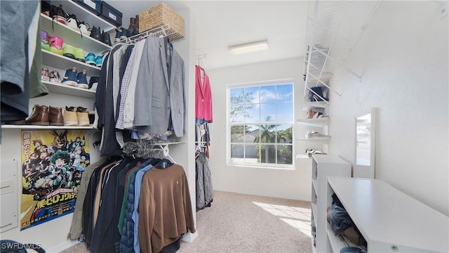 walk in closet featuring light colored carpet