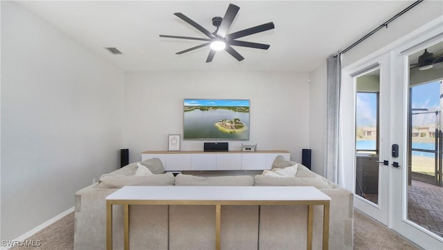 living area with french doors, light carpet, ceiling fan, and visible vents