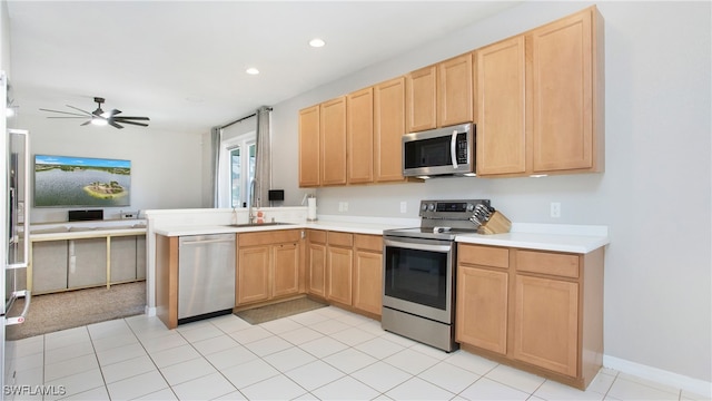 kitchen featuring kitchen peninsula, appliances with stainless steel finishes, ceiling fan, sink, and light brown cabinets