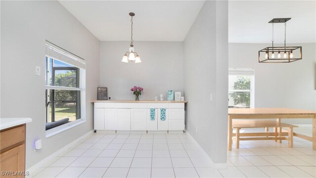 unfurnished dining area with light tile patterned floors