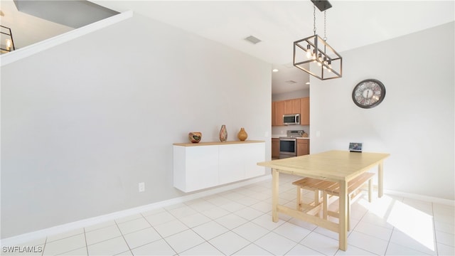 dining space featuring light tile patterned floors and a notable chandelier