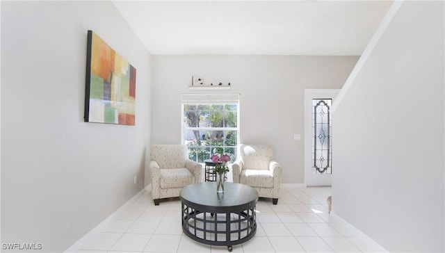 sitting room featuring light tile patterned floors and baseboards