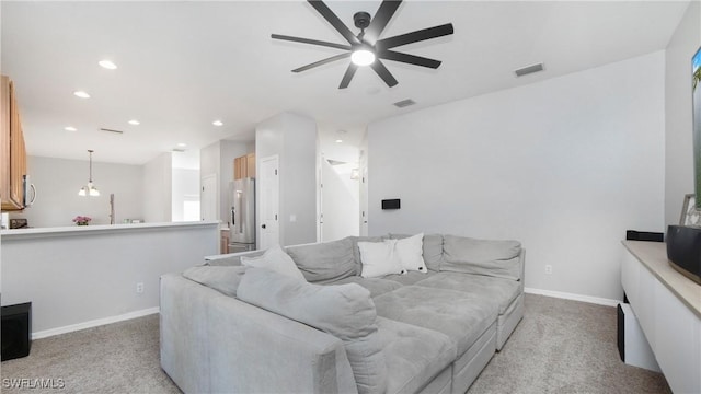 living room featuring light colored carpet, visible vents, baseboards, and recessed lighting