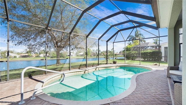 view of swimming pool featuring glass enclosure, a water view, and a patio