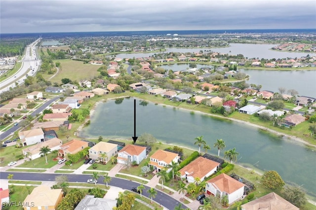 bird's eye view with a residential view and a water view