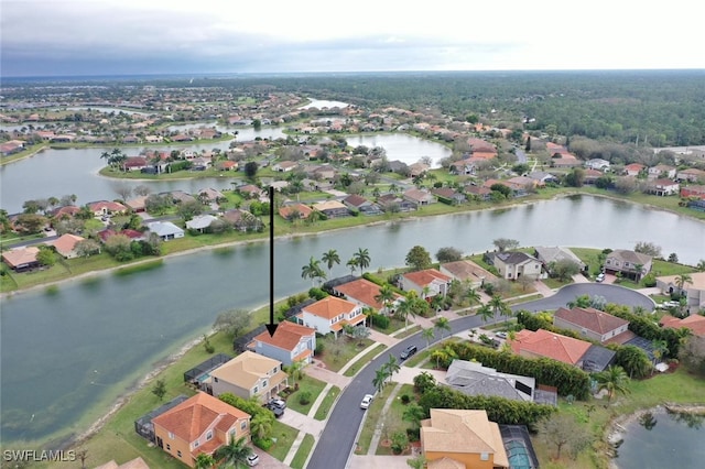 drone / aerial view with a water view and a residential view