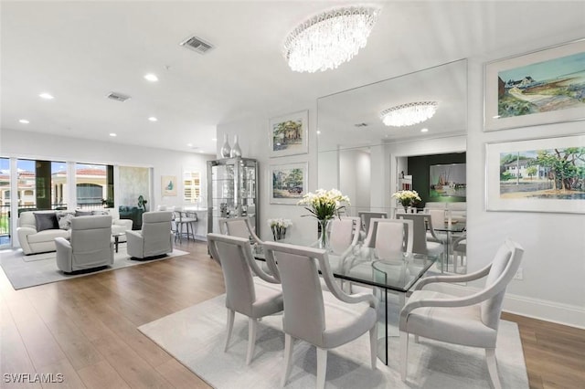 21490 Strada Nuova Cir Unit D307, Estero, FL 33928 - dining space featuring a chandelier, recessed lighting, wood finished floors, and baseboards