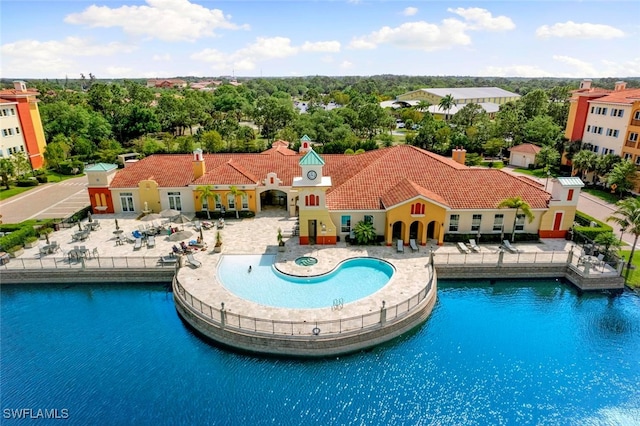 view of swimming pool featuring a water view and a patio