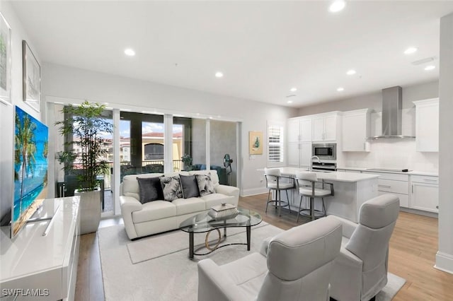 21490 Strada Nuova Cir Unit D307, Estero, FL 33928 - living area featuring recessed lighting, light wood-type flooring, and baseboards