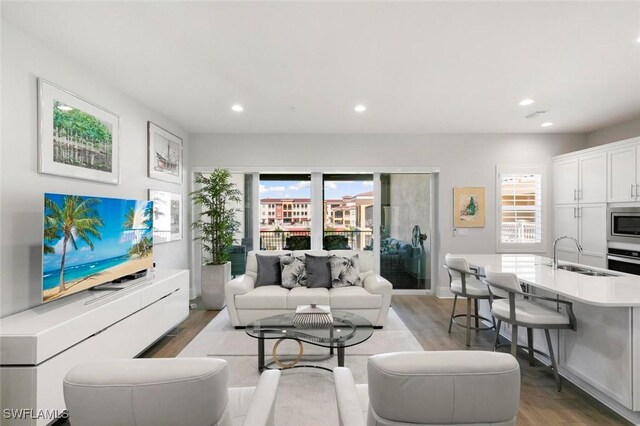 21490 Strada Nuova Cir Unit D307, Estero, FL 33928 - living room with light wood-type flooring and recessed lighting