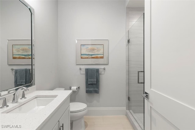 bathroom featuring tile patterned floors, an enclosed shower, vanity, and toilet