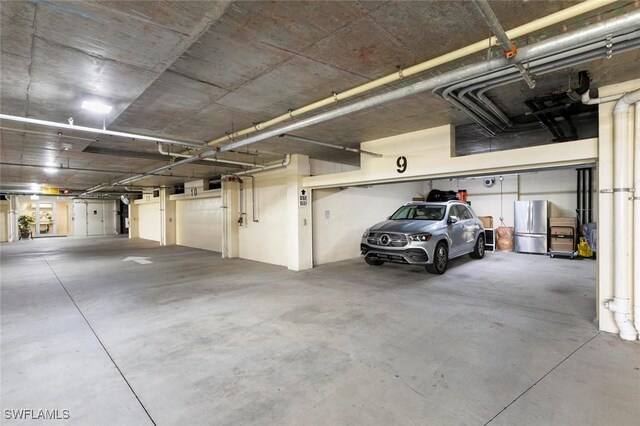 21490 Strada Nuova Cir Unit D307, Estero, FL 33928 - garage with freestanding refrigerator